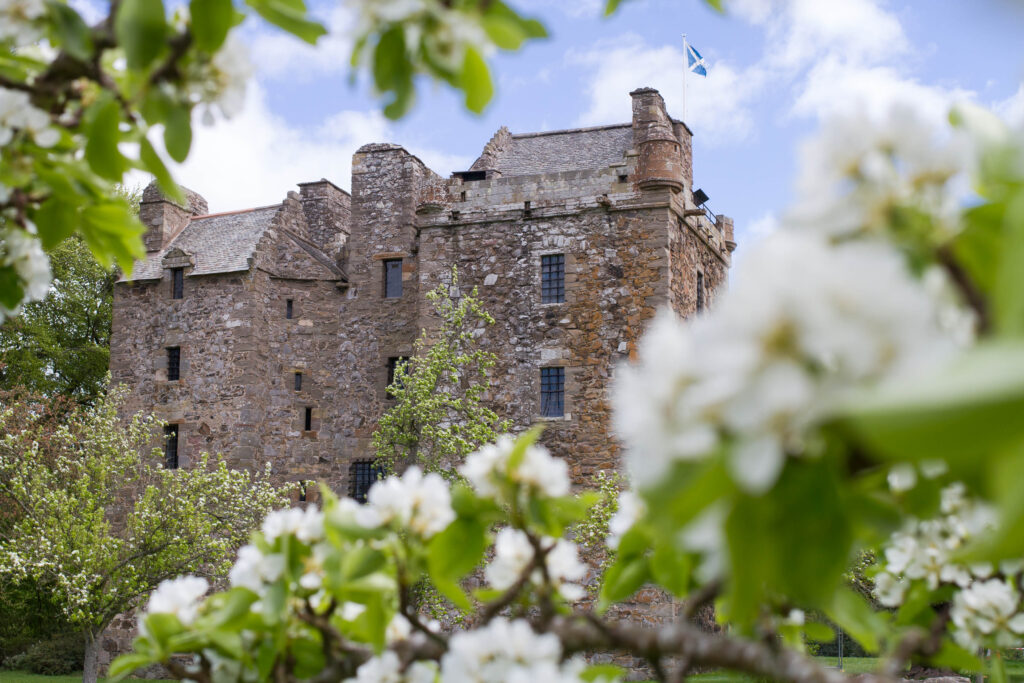 Elcho Castle in Perthshire with apple blossom in the foreground